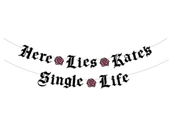 May include: A banner with the text "Here Lies Kates Single Life" in black gothic font, strung between two thin grey lines. Pink rose illustrations are interspersed between the words, set against a white background.