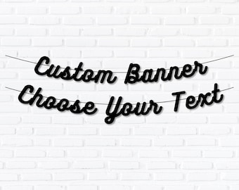 May include: Black banner with the text "Custom Banner Choose Your Text" in a cursive font, strung on a thin black string. The banner is set against a white brick wall.