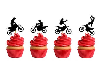 May include: Four red cupcakes with black silhouette cupcake toppers of motocross riders on dirt bikes. The toppers are attached to the cupcakes with toothpicks.