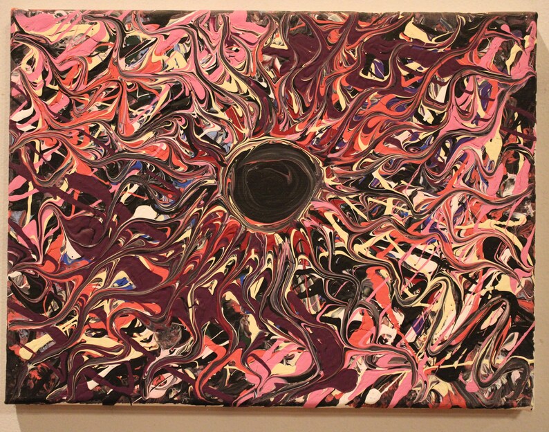 May include: Abstract acrylic painting on canvas. The artwork features a central black circle surrounded by swirling patterns in shades of pink, red, purple, black, and cream. The dynamic composition creates a sense of movement and depth.