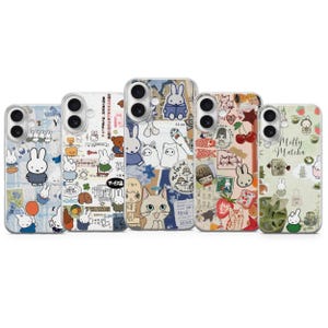May include: Five smartphone cases with colourful designs featuring cartoon rabbits, cats, and other illustrations. The cases have a clear border and a variety of patterns, including Japanese text, cherries, and strawberries.