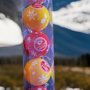 May include: A clear plastic package containing five round Christmas ornaments. The ornaments alternate between red and yellow, each decorated with white snowflakes. The red ornaments have the text "LVII-LVII Super Bowl Champions".