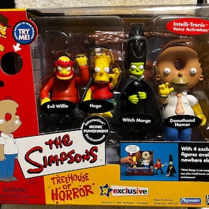May include: A boxed set of The Simpsons Treehouse of Horror action figures. The set includes figures of Evil Willie, Hugo, Witch Marge, and Donuthead Homer. The packaging features the show's logo and the text "exclusive".