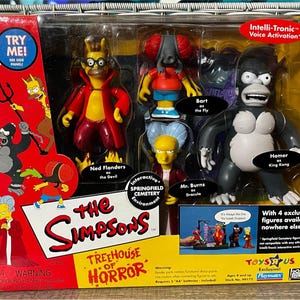 May include: A boxed set of The Simpsons Treehouse of Horror action figures. The set includes figures of Ned Flanders as the Devil, Bart as the Fly, Mr. Burns as Dracula, and Homer as King Kong. The packaging features the show's logo and the Toys R Us and Playmates logos.