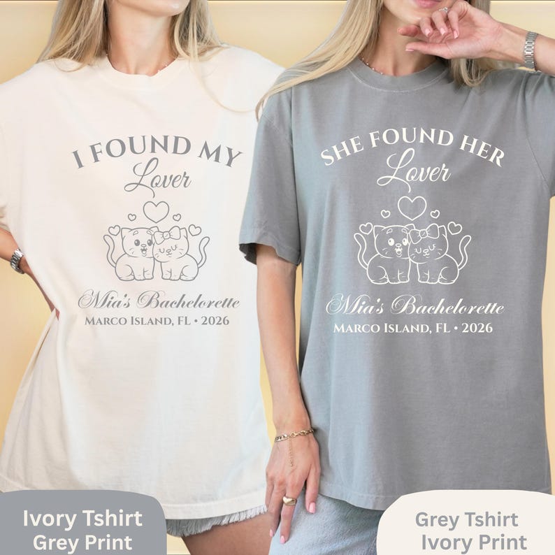 May include: Two t-shirts, one ivory and one grey, with matching text and graphics. The ivory shirt says "I FOUND MY Lover" above a graphic of two cats and "Mia's Bachelorette MARCO ISLAND, FL &bull; 2026". The grey shirt says "SHE FOUND HER Lover" with the same graphic and text.