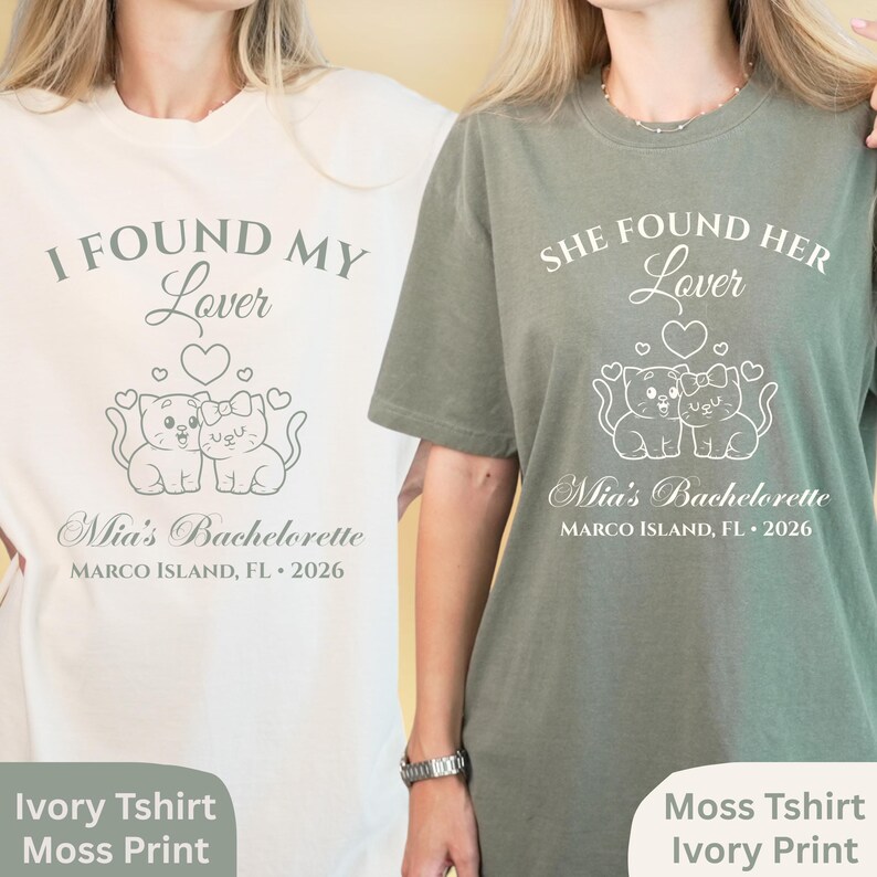 May include: Ivory and moss green t-shirts with white text and graphics. The ivory shirt reads "I FOUND MY Lover" above two cat illustrations and "Mia's Bachelorette, MARCO ISLAND, FL &bull; 2026". The moss shirt reads "SHE FOUND HER Lover" with similar design.