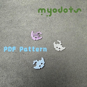 May include: Three beaded ghost designs in lavender, white, and light blue. The text "PDF Pattern" is in light blue, and the word "myodots" is in green. The ghosts are made of small beads.