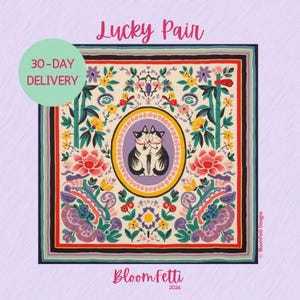 May include: Square scarf with a floral and cat design. The scarf features a central oval with two hugging cats, surrounded by colorful flowers, leaves, and bamboo. The text "Lucky Pair" is at the top, and "BloomFetti" is at the bottom.