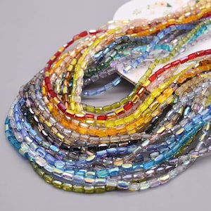 May include: A collection of colorful, rectangular glass beads in various shades, including red, yellow, blue, and iridescent. The beads are strung together, creating a vibrant and textured appearance. Ideal for jewelry making and crafting.