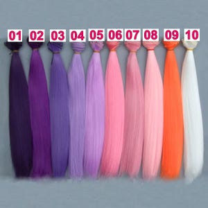 May include: Ten bundles of synthetic hair extensions in a spectrum of colours. The hues vary from deep purple to white, encompassing shades of purple, pink, and orange. Each bundle is labelled with a number from 01 to 10.