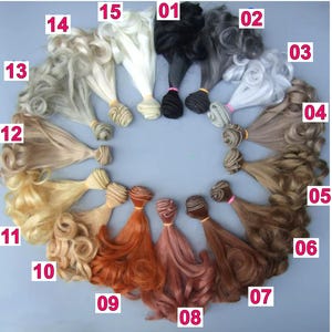 May include: A selection of doll hair in a circular pattern, showcasing a range of colours. The colours include black, grey, white, brown, blonde, and red. Each bundle is secured with an elastic band. The hair is styled in curls and waves.
