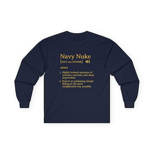 May include: Navy blue long-sleeve shirt with the text "Navy Nuke" in gold lettering. The shirt includes a definition of "Navy Nuke" with two points. The shirt is made of a soft, comfortable material.
