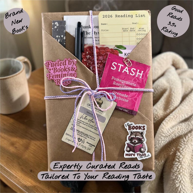 May include: A wrapped gift box with a variety of items, including a pen, tea packet, and a reading list. The box is tied with purple and white string and adorned with stickers that read "Fueled by Books & Feminine Rage" and "I love BOOKS More Than I like people."