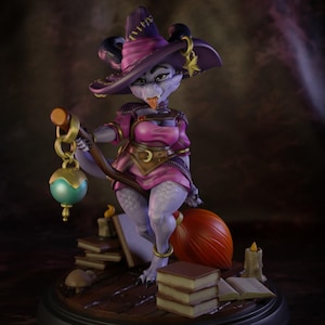 May include: A fantasy figurine of a witch-like creature with purple skin, wearing a pink dress and a purple hat. She is holding a lantern and sitting on a broom. Books and candles are at her feet. The figurine is on a wooden base.