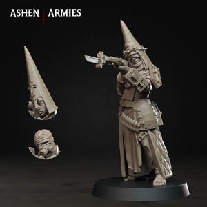 May include: A detailed, unpainted miniature figure of a character from "Ashen Armies." The figure is in a dynamic pose, holding a weapon. Additional components include a head with a pointed hat and a wrapped head with a gas mask. The figure is on a black base.