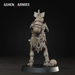 May include: A gray miniature figurine from Ashen Armies, viewed from the back. The figure wears a tattered garment, carries a large bomb strapped to its back with rope, and has a ball and chain attached to one ankle, all standing on a circular base.