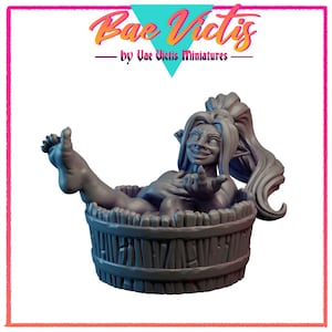 May include: A gray miniature figure of a smiling woman with pointed ears, reclining in a wooden barrel. The figure has long hair pulled back in a ponytail and is holding out one hand. The text "Bae Victis" is above the figure.