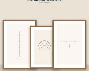 May include: A set of three framed botanical wall art prints with a beige background. The first print shows a vertical line with small leaves, the second a multi-colored rainbow, and the third the text GROW THROUGH WHAT YOU GO THROUGH.