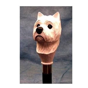 May include: A white wooden West Highland White Terrier dog head cane topper. The dog has black eyes and a black nose.