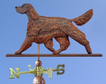 May include: A wooden Irish Setter dog weathervane with a brown finish. The weathervane is mounted on a wooden post with a copper ball finial and a compass rose.