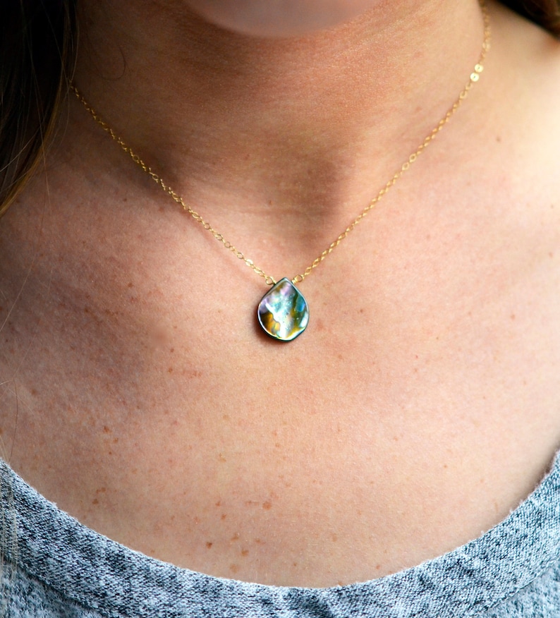 Abalone teardrop set onto a 14k gold filled chain necklace.