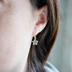 Labradorite moon and star earrings in gold or silver. Shown in gold. One earring is a crescent moon, the other a star.