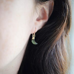 Labradorite moon and star earrings in gold or silver. Shown in gold. One earring is a crescent moon, the other a star.