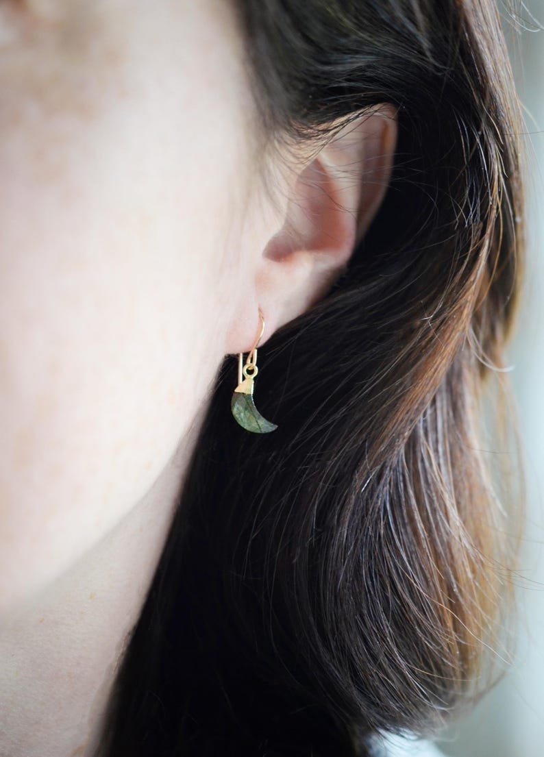 Labradorite moon and star earrings in gold or silver. Shown in gold. One earring is a crescent moon, the other a star.