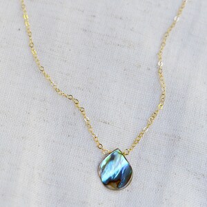 Abalone teardrop set onto a 14k gold filled chain necklace.