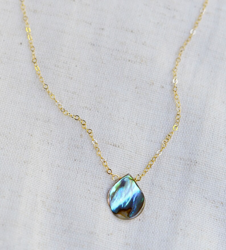 Abalone teardrop set onto a 14k gold filled chain necklace.