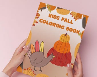 May include: A fall-themed coloring book for kids, held by a person. The cover features a cartoon turkey, pumpkins, and the text "KIDS FALL COLORING BOOK" in orange and brown. The background is a gradient of light brown and orange.