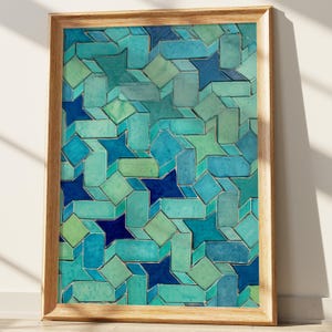 May include: Framed artwork featuring a geometric pattern of interlocking shapes in shades of teal, turquoise, and navy blue. The design includes star-like forms and rectangular blocks, creating a three-dimensional effect. The artwork is encased in a light brown wooden frame.