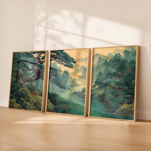 May include: Three framed landscape art prints. Each print features a serene Asian-inspired scene with lush green trees, a river, and mountains. The artwork has a warm color palette with gold and green tones.
