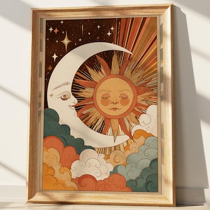 May include: A framed wall art print featuring a stylized crescent moon with a face and a sun with a face, surrounded by radiating light rays, stars, and layered clouds in shades of orange, teal, cream, and dark brown within a light wood frame.