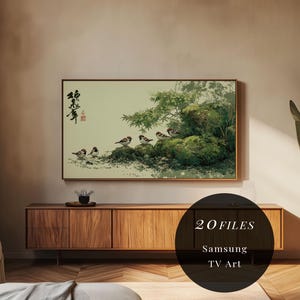 May include: A framed artwork featuring a traditional Asian-style painting of birds perched on a mossy rock formation with green foliage. The artwork is displayed above a wooden cabinet. The image also includes the text "20 FILES" and "Samsung TV Art".
