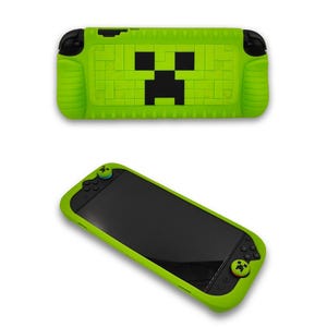May include: Bright green protective case for a handheld gaming device, featuring a pixelated black and green design on the top. The case has a black screen and green buttons. The design resembles a popular video game character.
