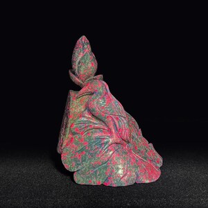 May include: A hand-carved stone sculpture featuring a bird perched atop a large leaf, with a closed flower bud extending upward. The material is a mottled green and vibrant pink stone, showcasing natural color variations throughout the entire piece.
