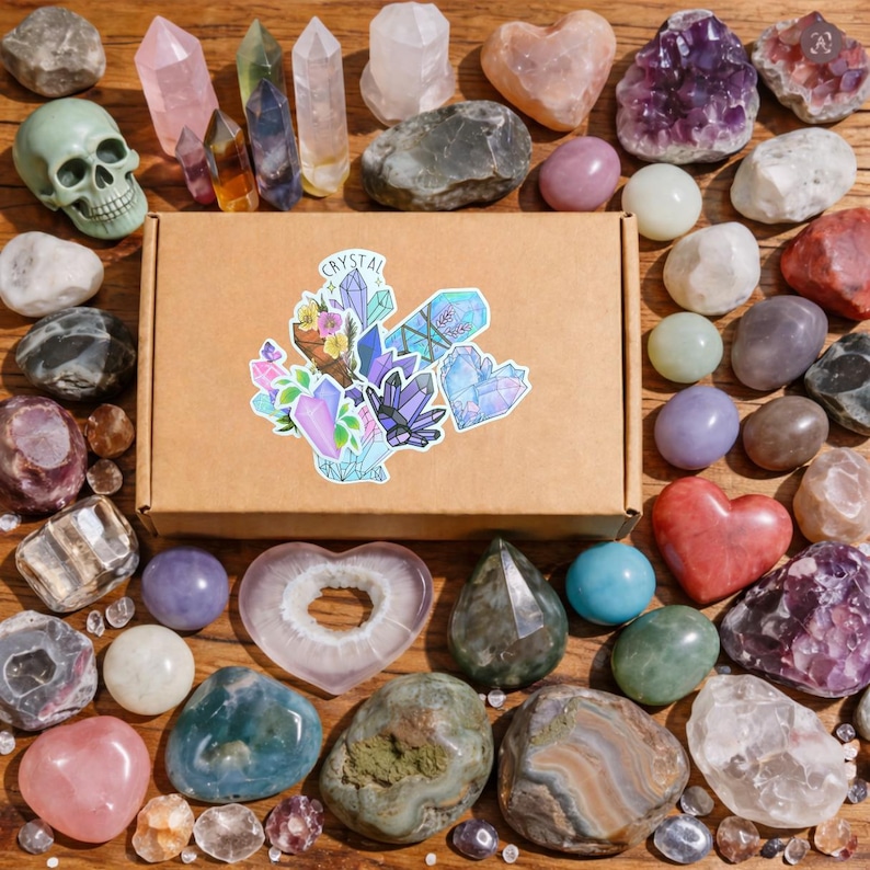 May include: An assortment of crystals and gemstones, including amethyst, quartz, and agate, arranged around a cardboard box with a crystal-themed sticker. The crystals vary in shape, size, and color, with some polished and others in their natural form.