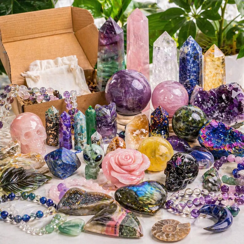 May include: A collection of various crystals and gemstones, including amethyst, rose quartz, and fluorite. The assortment features crystal points, spheres, skulls, and carvings, along with beaded bracelets. Colors include purple, pink, green, blue, and yellow.