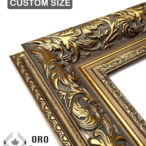 May include: Close-up of a decorative picture frame corner. The frame is gold and dark grey with ornate floral detailing. The text "CUSTOM SIZE" is at the top. The text "ORO Frame" is at the bottom.