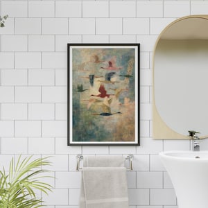 May include: A framed art print featuring a flock of birds in flight. The birds are depicted in various colors, including red, blue, and green, against a textured, muted background. The artwork is displayed in a bathroom setting.