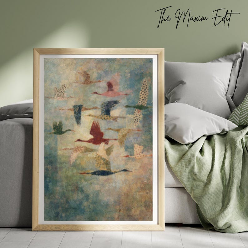 May include: A framed art print featuring a flock of birds in flight. The birds are depicted in various colors, including red, blue, and beige, against a textured, blue and beige background. The text "The Maxim Edit" is in the upper right corner.