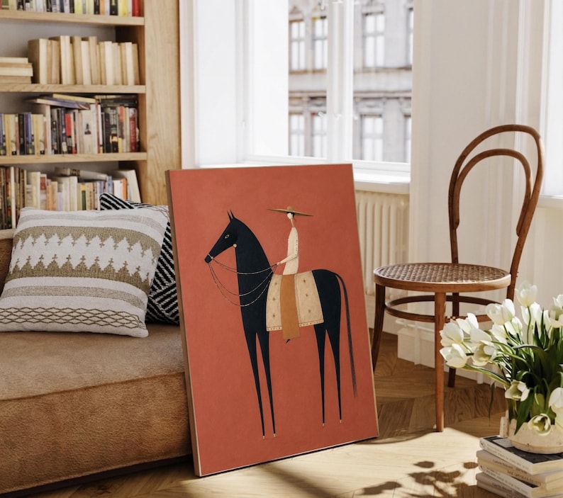 Folk art print of a figure in a wide-brim hat riding a tall dark horse with a tan saddle blanket on a warm terracotta background, vertical mid century equestrian wall art.