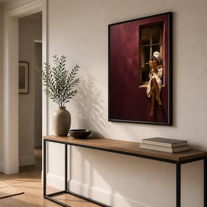Painting of a Black woman in a white towel reading a golden book on a sunlit windowsill against a deep burgundy wall, moody figurative wall art print.
