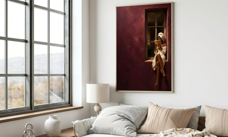 Painting of a Black woman in a white towel reading a golden book on a sunlit windowsill against a deep burgundy wall, moody figurative wall art print.
