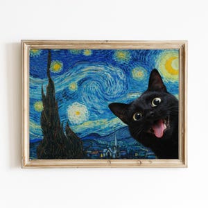 May include: A framed print showing a black cat superimposed on a parody of Van Gogh's "Starry Night." The artwork is in a gold frame and depicts a swirling blue night sky with yellow stars and a crescent moon. The cat is smiling.