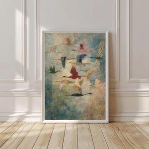 May include: A framed art print featuring a flock of birds in flight. The birds are depicted in various colors, including red, pink, and green, with some featuring patterned wings. The background has a soft, textured appearance with shades of blue and green.