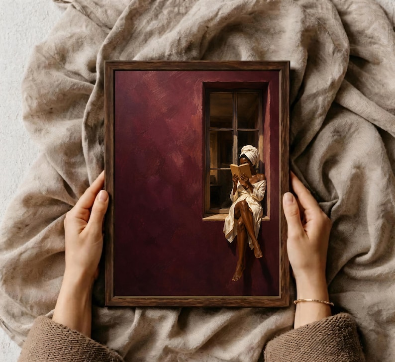 Painting of a Black woman in a white towel reading a golden book on a sunlit windowsill against a deep burgundy wall, moody figurative wall art print.