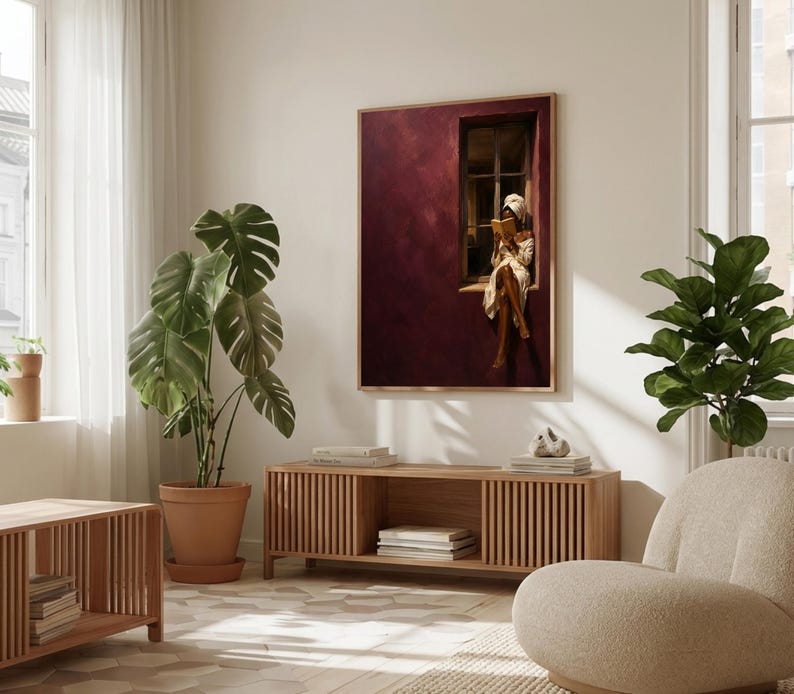 Painting of a Black woman in a white towel reading a golden book on a sunlit windowsill against a deep burgundy wall, moody figurative wall art print.