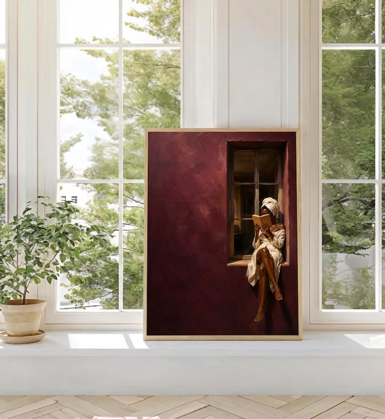 Painting of a Black woman in a white towel reading a golden book on a sunlit windowsill against a deep burgundy wall, moody figurative wall art print.
